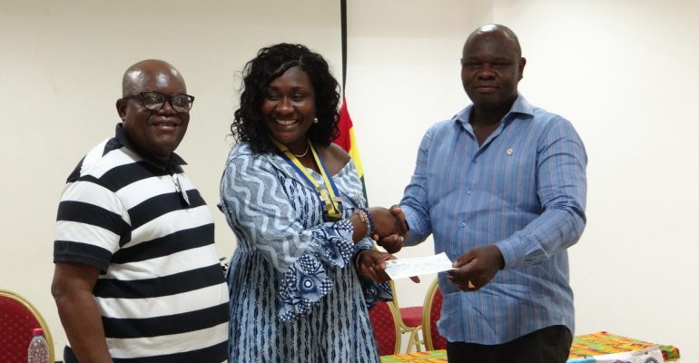 Rotarian Stanley Owusu Presenting the cheque to Club President Jennifer